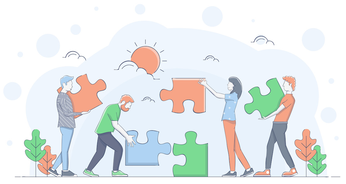 Engaged employees demonstrating teamwork by putting a puzzle together